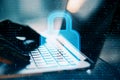 Close up of backlit female hands using laptop with abstract glowing padlock interface on blurry outdoor background. Safety,