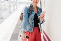 Close up of backpacker caucasian woman holding luggage at train station ready to catch the train. Holding mobile phone while using Royalty Free Stock Photo