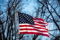 Close-up of a badly tattered American flag flying from flagpole outside Royalty Free Stock Photo