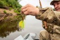 Close-up bait for fish on fishing spinnerbait yellow in the hands of the fisherman Royalty Free Stock Photo