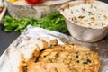 Close up of baked chicken breast on foil near plate of rice, veg Royalty Free Stock Photo