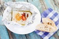 Close up of baked feta-cheese with bread slices on napkin Royalty Free Stock Photo