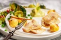 Close-up Baked sea fish fillet with vegetables. Tilapia fillet with broccoli, cherry tomatoes, fried potatoes, green peas Royalty Free Stock Photo