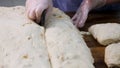 Close up for baker cutting dough into pieces before cooking and weighing them at the bakery. Stock footage. Woman making Royalty Free Stock Photo