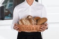 Baker Holding A Basket Of Bread Loaf