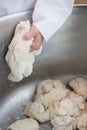 Close up of baker preparing dough in industrial mixer Royalty Free Stock Photo