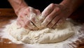 Close up of baker s hands kneading fresh dough for artisan bread in a bakery