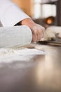 Close up of baker using a rolling pin