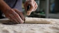 Close-up of a baker& x27;s hands making baking dough. Male chef& x27;s hands roll out dough close-up. Male hands roll out Royalty Free Stock Photo