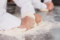 Close up of bakers kneading dough at counter Royalty Free Stock Photo