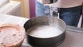 Close-up of bakery concept - Woman flouring a baking dish for a cake