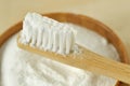 Close-up of baking soda in a bowl with a wooden toothbrush - Teeth whitening