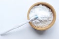 Close up of baking soda (sodium bicarbonate) in a wooden bowl with a toothbrush on white background. Royalty Free Stock Photo