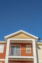 Close up of the balcony of a home with a combination of white and otange wall