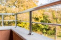 Close up of a balcony metal balustrade. Autumn view in the background. Royalty Free Stock Photo