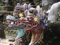 Close up of Balinese dragon gods with egg in mouth at Pura Sangara sea temple near Sanur, Bali