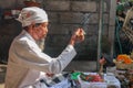 Close up of a Balinese pedanda during prayer. side view of a hindu priest performing a ceremony. A hindu priest performing