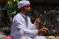 Close up of a Balinese pedanda during prayer. side view of a hindu priest performing a ceremony. A hindu priest