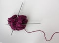 close-up of a ball of marsala yarn and two knitting needles Royalty Free Stock Photo