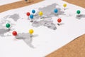 Close up of ball pins on world map on Corkboard