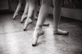 Close-up of ballerina feet on pointe shoes in the dance hall. V