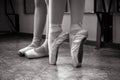 Close-up of ballerina feet on pointe shoes in the dance hall. Vintage photography. Close-up of a ballerina in the dance hall. Royalty Free Stock Photo