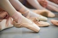 Close up ballerina tying pointe shoes. Royalty Free Stock Photo