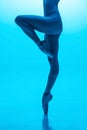 Close-up ballerina& x27;s legs in pointe shoes isolated on navy color studio background in neon. Art, motion, action Royalty Free Stock Photo