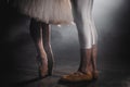 Close up of ballet couple of dancers as they practices exercises on dark stage or studio. Woman`s and man`s feet in Royalty Free Stock Photo