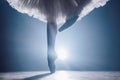 Close up of ballet dancer as she practices exercises on dark stage or studio. Woman`s feet in pointe shoes. Ballerina Royalty Free Stock Photo