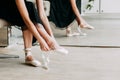 Close up for ballet dancer putting on, tying ballet shoes. Ballerina putting on her pointe shoes Royalty Free Stock Photo