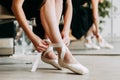 Close up for ballet dancer putting on, tying ballet shoes. Ballerina putting on her pointe shoes Royalty Free Stock Photo