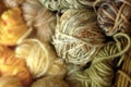 Close-up of Balls of yarn in Varying Sizes, Colors, Textures, Mostly Yellow, Gold, Pale Green
