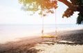 Close up bamboo swing hanging under big tree on the beach Royalty Free Stock Photo