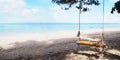 Close up bamboo swing hanging under big tree on the beach Royalty Free Stock Photo