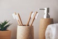 Close up of bamboo toothbrushes in a cup