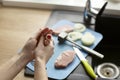 Close-up of a bandage on a finger. The woman injured her finger while cooking. Caring for a bloody wound at home Royalty Free Stock Photo