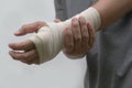 Close-up bandaged wrist men`s pain his hand after work.