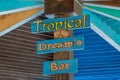 Close-up of a bar on the beach with a sign: tropical dreams bar