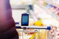 Close up of bar code scanner on shopping cart in store. Concept of modern gadgets Royalty Free Stock Photo