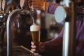 Close-up of bar tender filling beer from bar pump Royalty Free Stock Photo