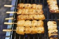 Close up of barbecue grill salmon skewers on wooden sticks, thai street food market Royalty Free Stock Photo