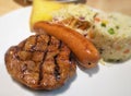 Close up barbecue steak and sausage on white dish Royalty Free Stock Photo