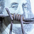 Close up barbed wire against US Dollar bill Royalty Free Stock Photo