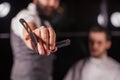 Close up of Barber holding professional equipment tools of Hairdresser -scissors