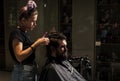 Close-up of barber styling beard to man in barbershop, Personal stylist barber