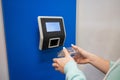 Close-up barcode price scanner on the wall in a store. Faceless woman buyer independently checks the value of the goods.