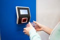 Close-up barcode price scanner on the wall in a store. Faceless woman buyer independently checks the value of the goods.