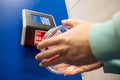 Close-up barcode price scanner on the wall in a store. Faceless woman buyer independently checks the value of the goods.