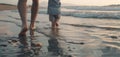 Close-up of bare feet of an adult and child walking on the beach shore. Royalty Free Stock Photo